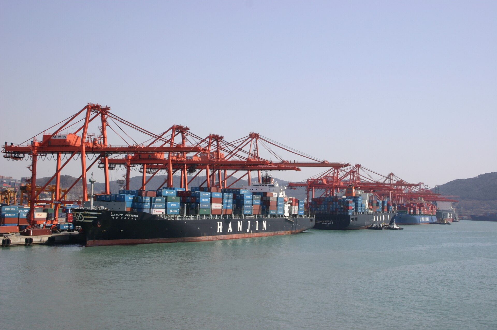 Commercial shipping container vessel and automated crane infrastructure at a deepwater industrial port