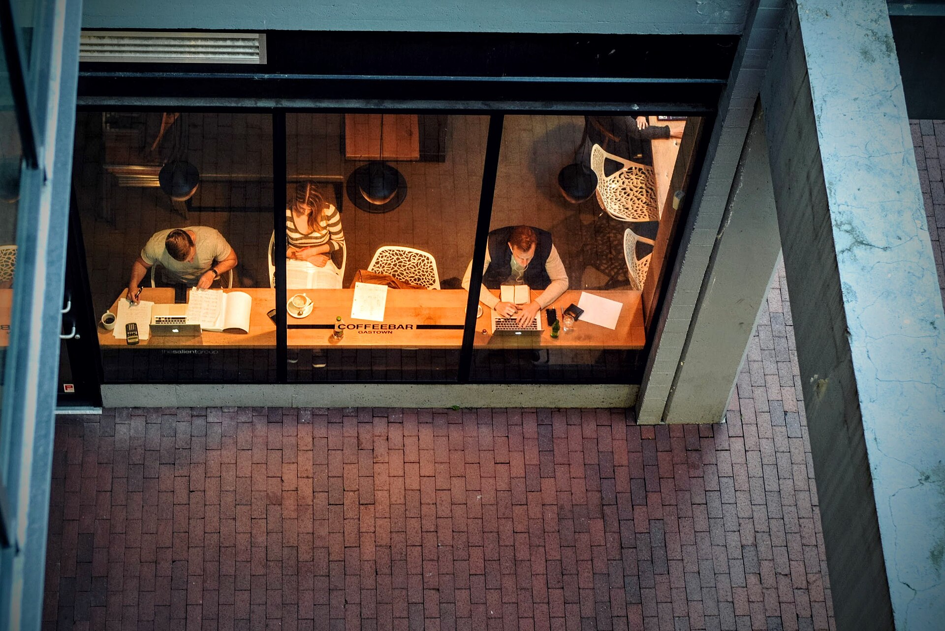 Open laptops and coffee cups on a shared café table