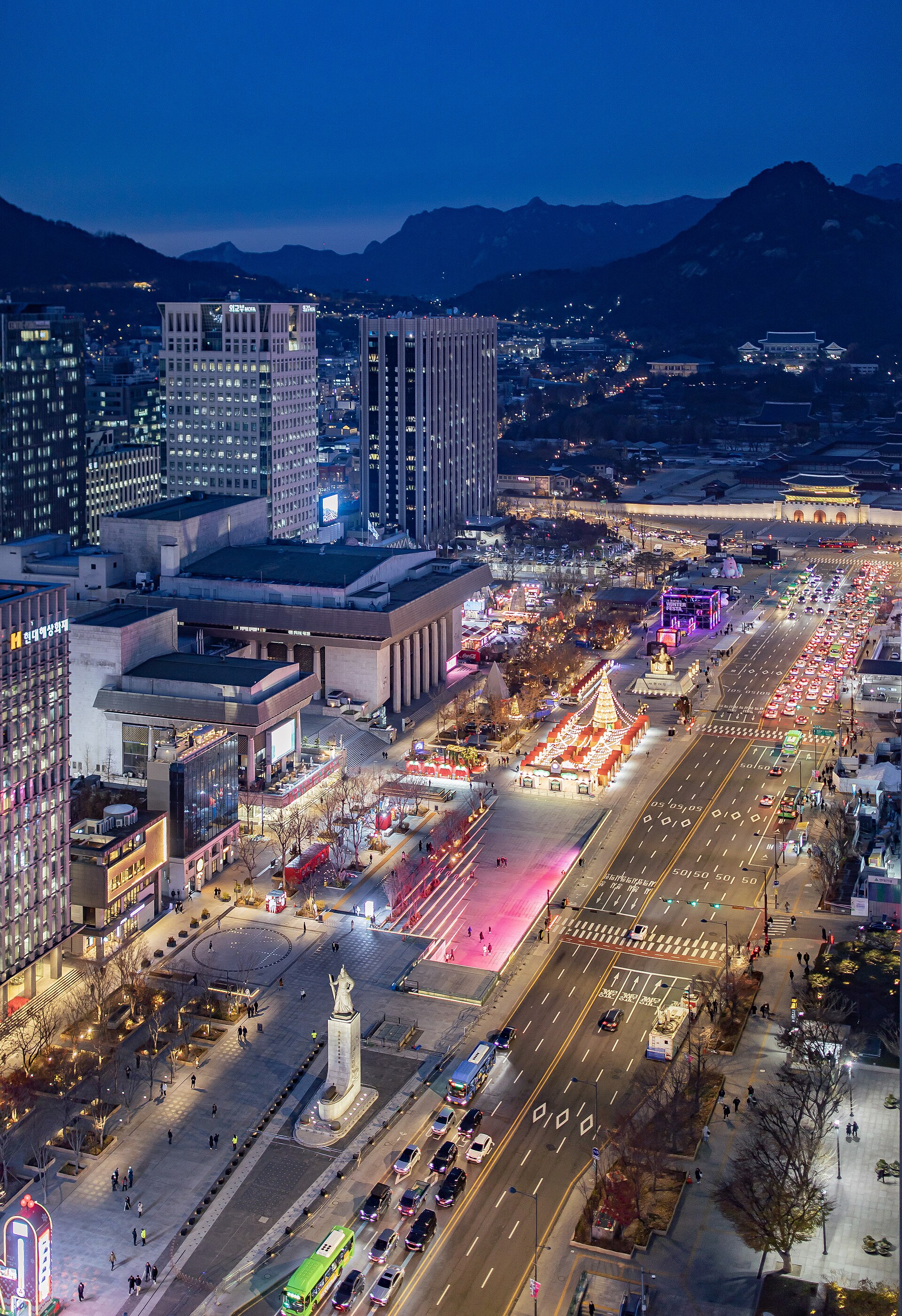 Gwanghwamun Square in Seoul at night, with the statues, the gate and the Government Complex behind