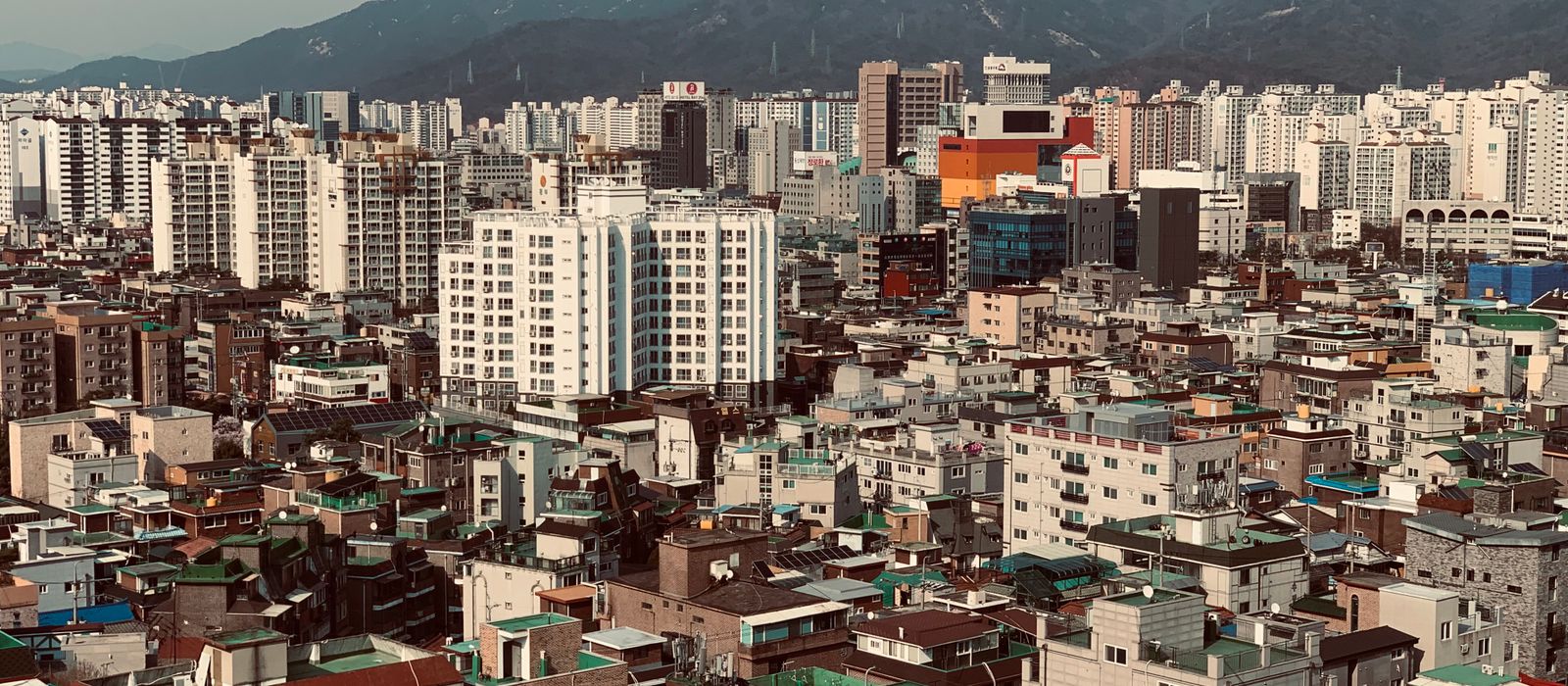 Aerial view of dense Korean city blocks and surrounding hills